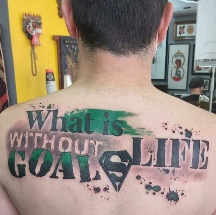 Tattoo with misspelled words and comic-themed design, a perfect example of signs that went so wrong comedic gold.