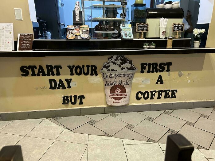 Comedic sign at coffee shop with scrambled words saying start your day but first a coffee, humorous error.