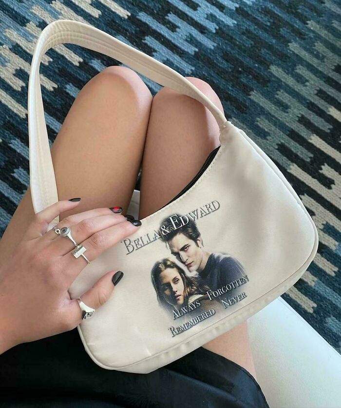 Hand holding a handbag with a Twilight-themed graphic, an example of signs that went so wrong and turned into comedic gold.