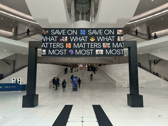 Large digital sign in a modern building displaying a confusing message with emojis, an example of signs that went wrong.