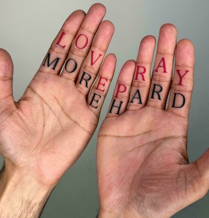 Hands with tattoos spelling love more pay hard, an example of signs that went so wrong they turned into comedic gold.