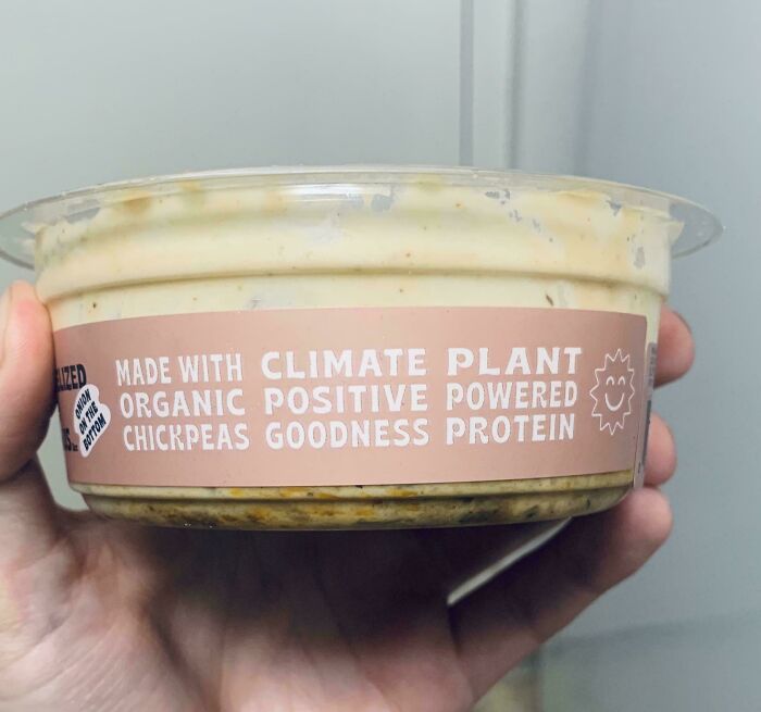 Hand holding a container with a label featuring a sign fail involving the phrase climate plant, comedic gold from signs.