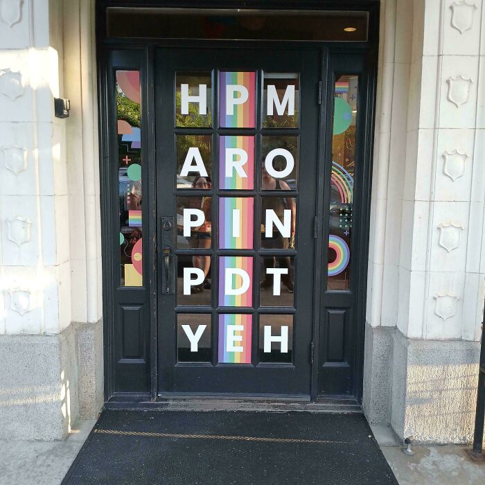 Door with scattered letters that fail to form a clear message, an example of signs that went wrong comedic gold.