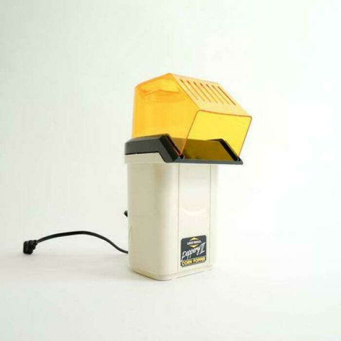 An old-fashioned white and yellow popcorn maker, a classic image that will remind you how old you are.