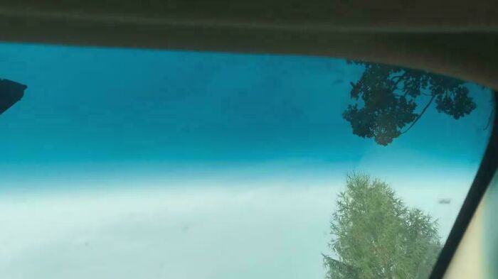 Looking through a vehicle's windshield with a blue tint, a nostalgic image that takes you way back.