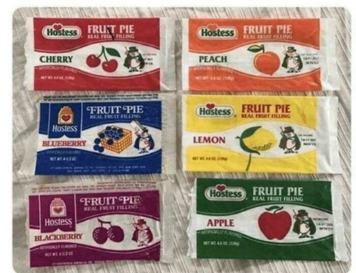 A display of six vintage Hostess Fruit Pies with various fruit fillings, reminding you how old you are.