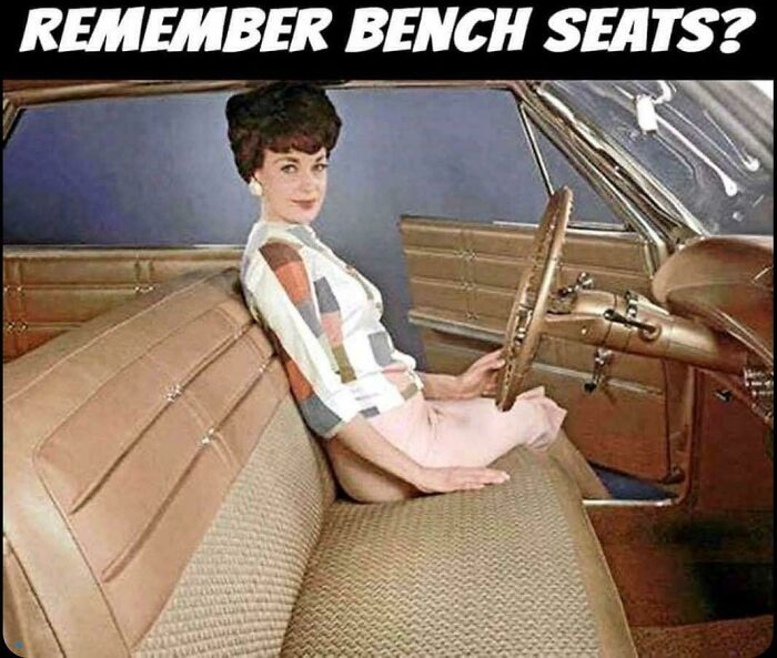 A vintage image of a woman sitting on a car bench seat, taking you way back to classic automobile design.