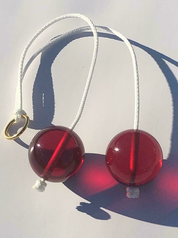 Red clackers with white strings, a popular toy that might take you way back and remind you how old you are.