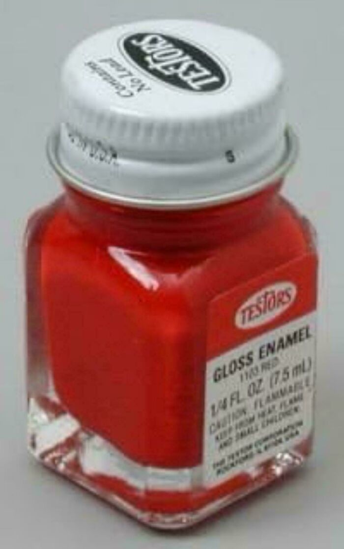 Small red Testors gloss enamel paint bottle, 1/4 fl. oz., evokes memories for those who remember how old you are.