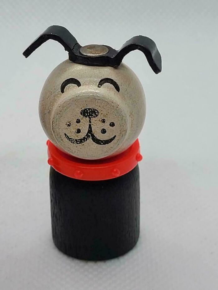 A vintage wooden dog toy with a red collar, reminding you how old you are with this classic item.