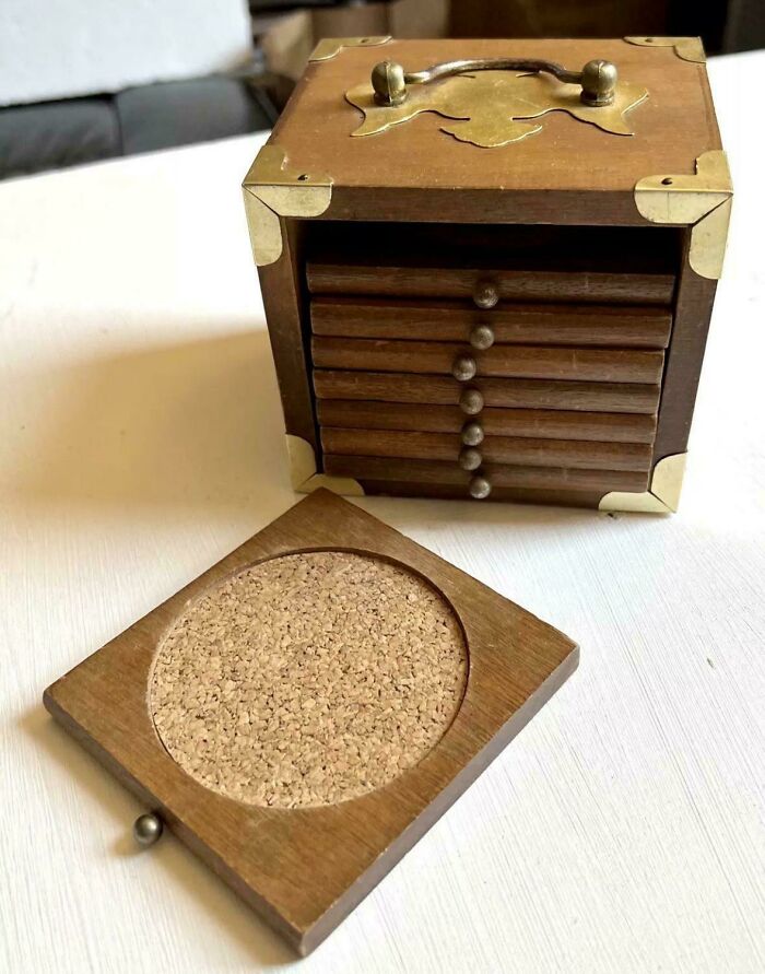 A vintage wooden coaster set with brass accents and a cork-lined coaster, reminding us of images that take you back.
