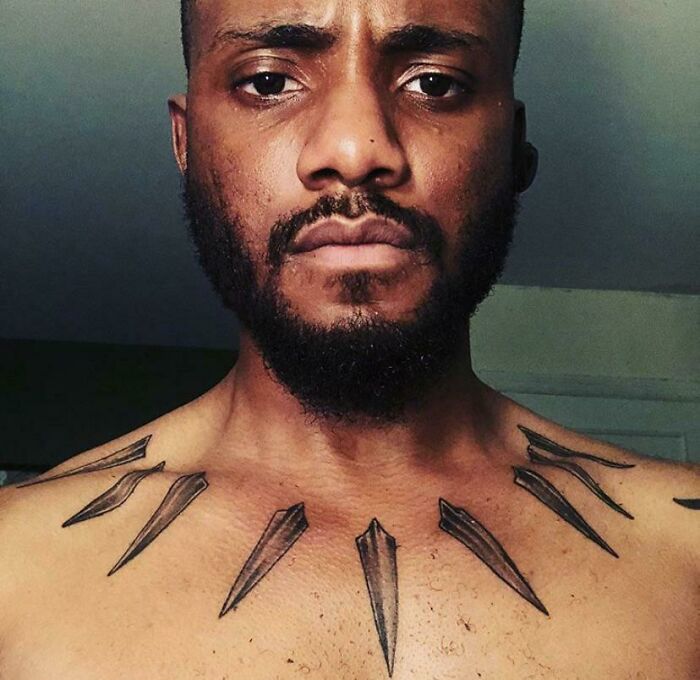 Man with cool tattoos on chest designed as sharp spikes in a symmetrical pattern, showing unique body art details.