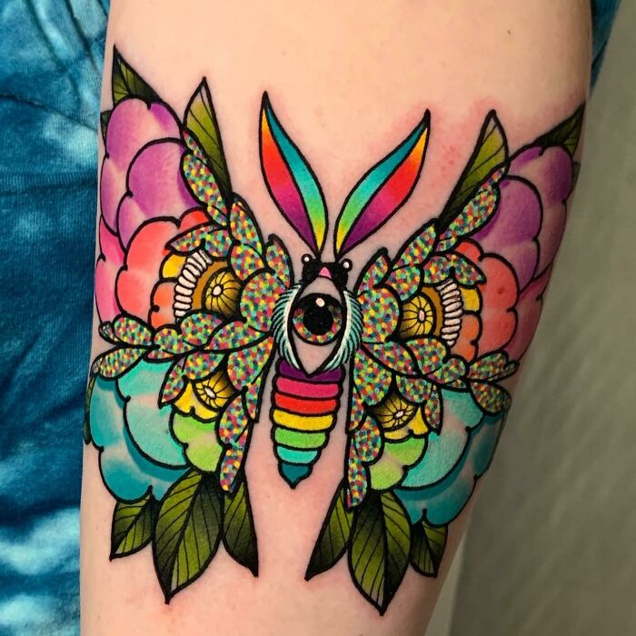 Colorful butterfly tattoo with floral and leaf patterns in vibrant shades, showcasing cool tattoos with no permanent regrets.