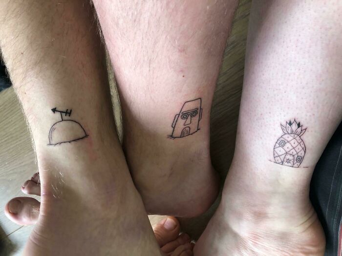 Three cool tattoos on ankles featuring simple black line art designs, showcasing unique and creative tattoo ideas.