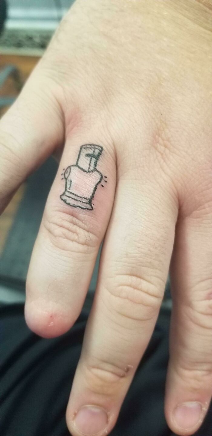 Small cool tattoo of a chess rook piece on a finger, showcasing a minimalistic and unique ink design.