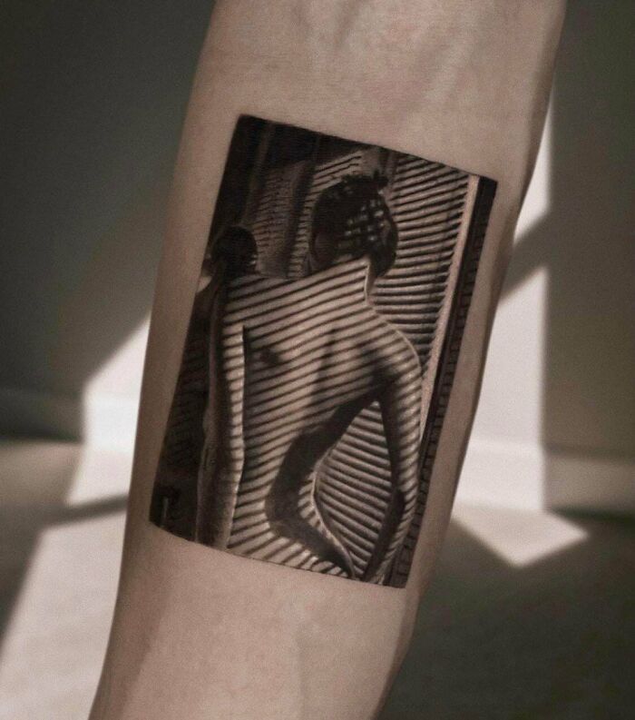 Realistic black and gray tattoo of a woman with shadow stripes on an arm, showcasing cool tattoos with no regrets.