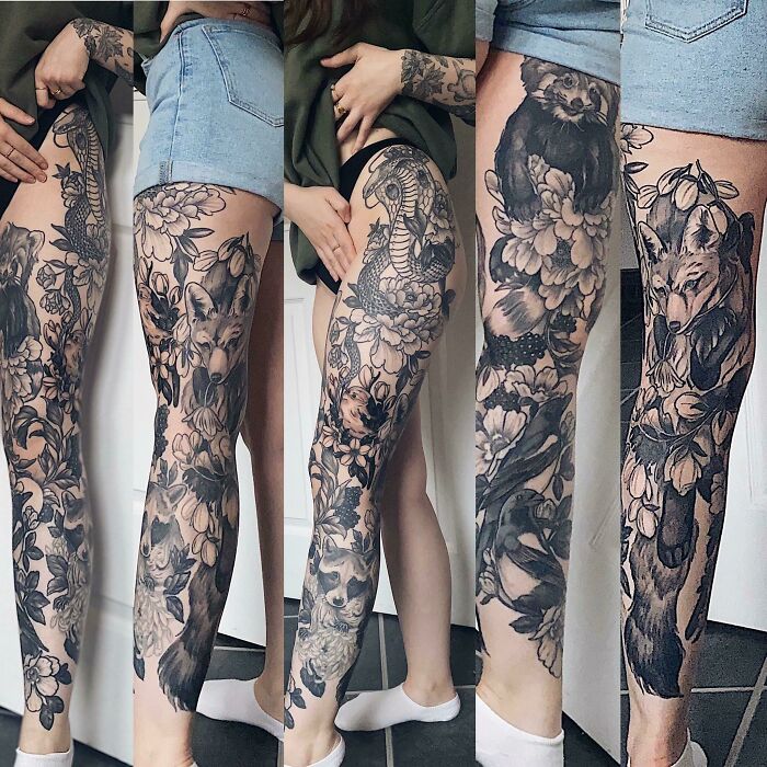 Detailed black and grey tattoo sleeve with floral and animal designs on a person's leg, showcasing cool tattoos.