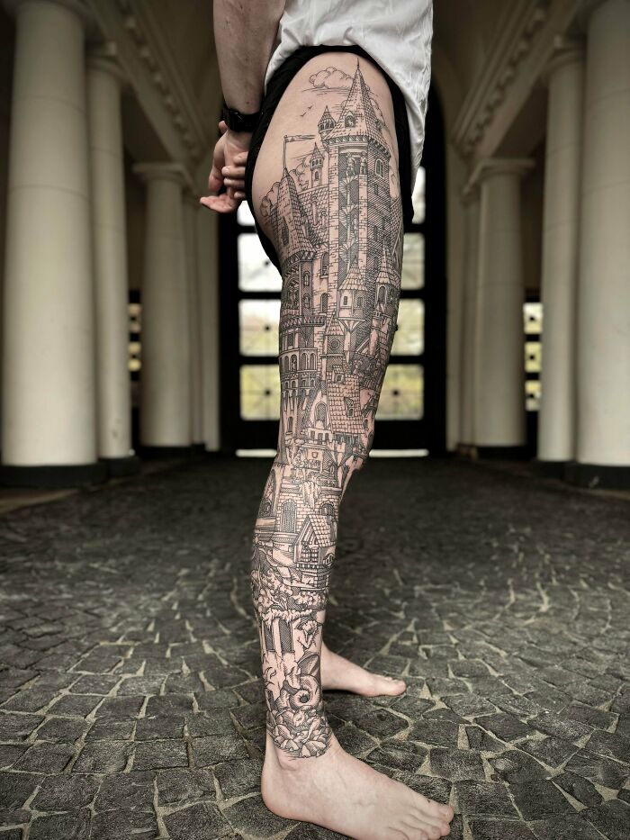 Full leg tattoo featuring a detailed castle design, showcasing cool tattoos that didn’t turn into permanent regrets.
