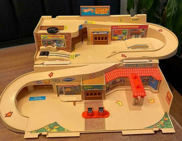 Vintage toy car service center playset with ramps and retro gas station signs, evoking nostalgic Gen X memories.