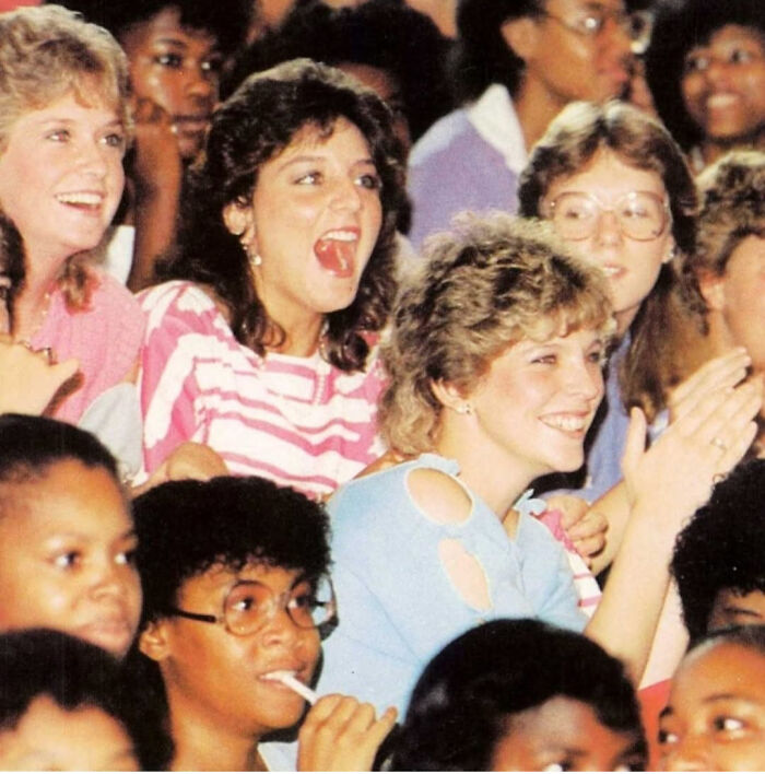 Group of nostalgic Gen X people smiling and reacting excitedly at a lively event, capturing relatable vintage 1980s vibes.