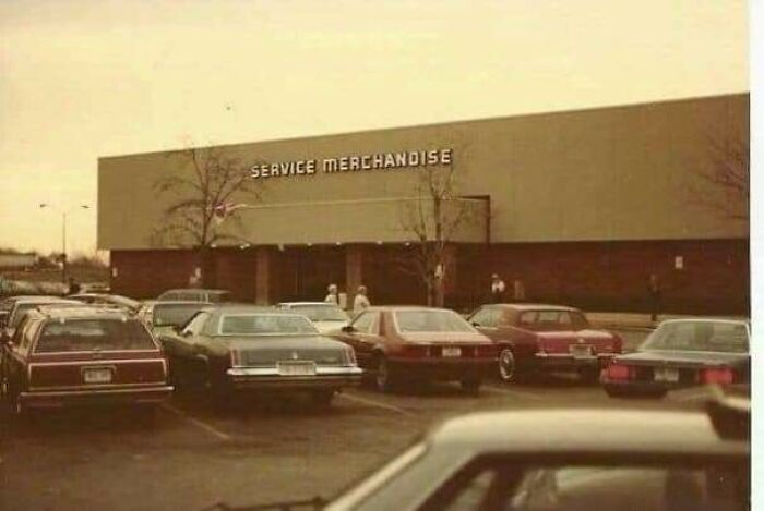 Vintage Service Merchandise store parking lot filled with classic cars, evoking nostalgic and relatable Gen X memories.
