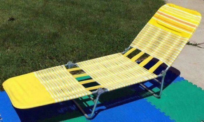 Yellow and white woven lawn chair on colorful foam mats next to grass, evoking nostalgic Gen X outdoor memories.