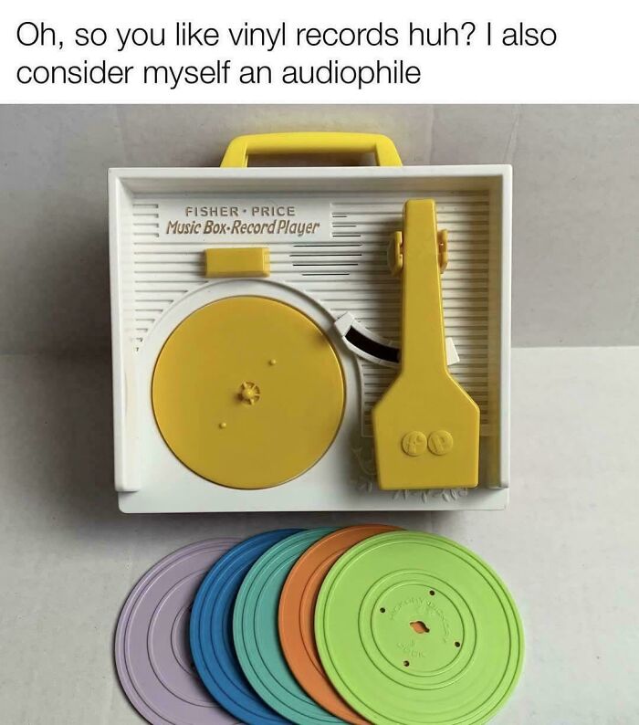 Vintage Fisher-Price music box record player with colorful plastic records, capturing nostalgic Gen X vibes and relatable retro tech.