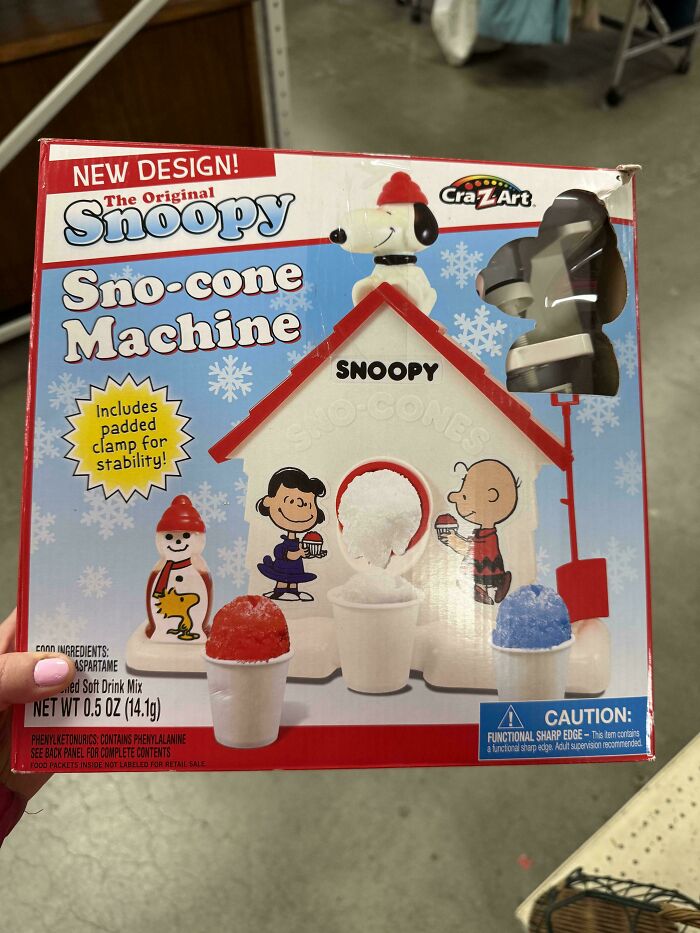 Vintage Snoopy Sno-cone machine in original packaging with cartoon characters and colorful shaved ice cups for Gen X nostalgia.