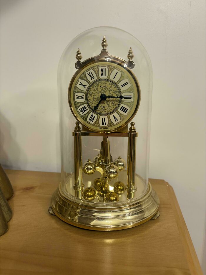 Vintage anniversary clock with gold accents and glass dome, evoking nostalgic and relatable Gen X memories.