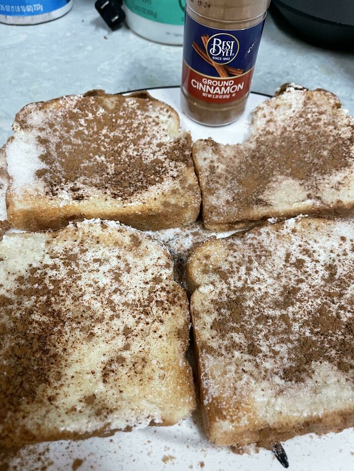 Four slices of toast sprinkled with sugar and ground cinnamon, evoking nostalgic Gen X breakfast memories.