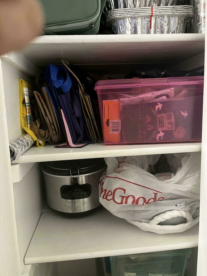 Closet shelves filled with bags, containers, and a slow cooker showing a perfectly camouflaged item to find.