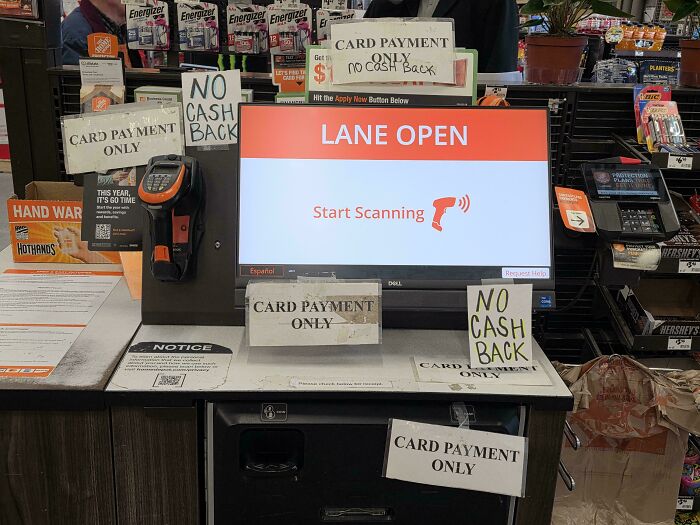 Home Depot checkout screen surrounded by multiple card payment only and no cash back signs