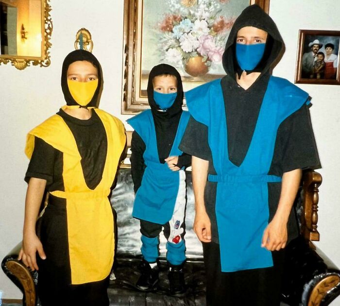 Three kids in homemade colorful ninja costumes wearing masks, evoking 90s nostalgic childhood memories and fun dress-up play.
