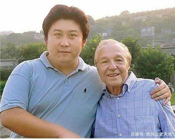 Two men standing outdoors posing for a photo together