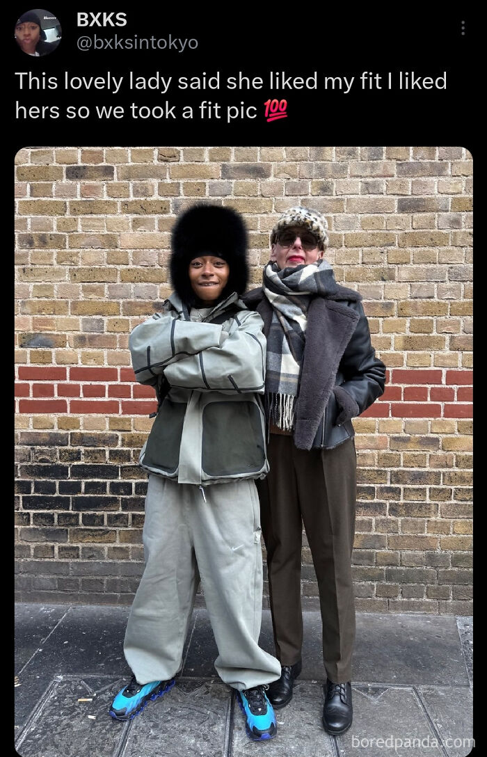 Two people smiling and posing together showing their fashion outfits on the street