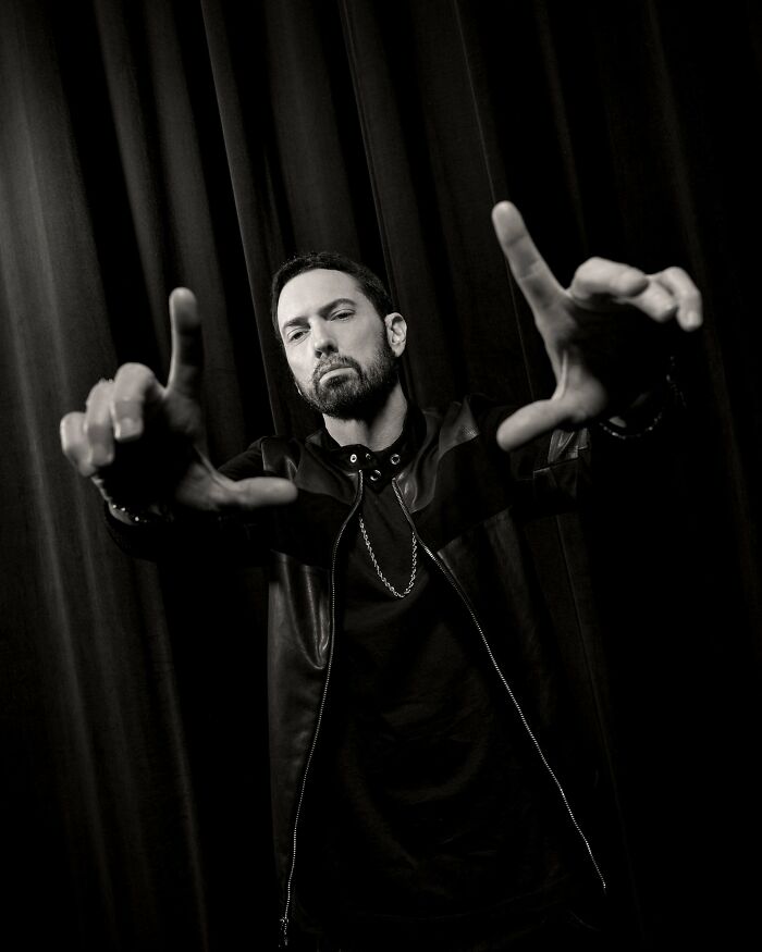 Black and white photo of Eminem posing with hands framing his face