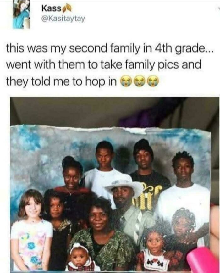 Fourth grader included in group family photo as second family