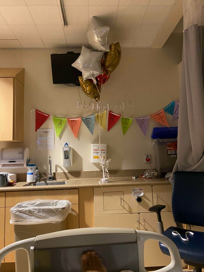 Hospital room decorated with happy birthday balloons and colorful banner