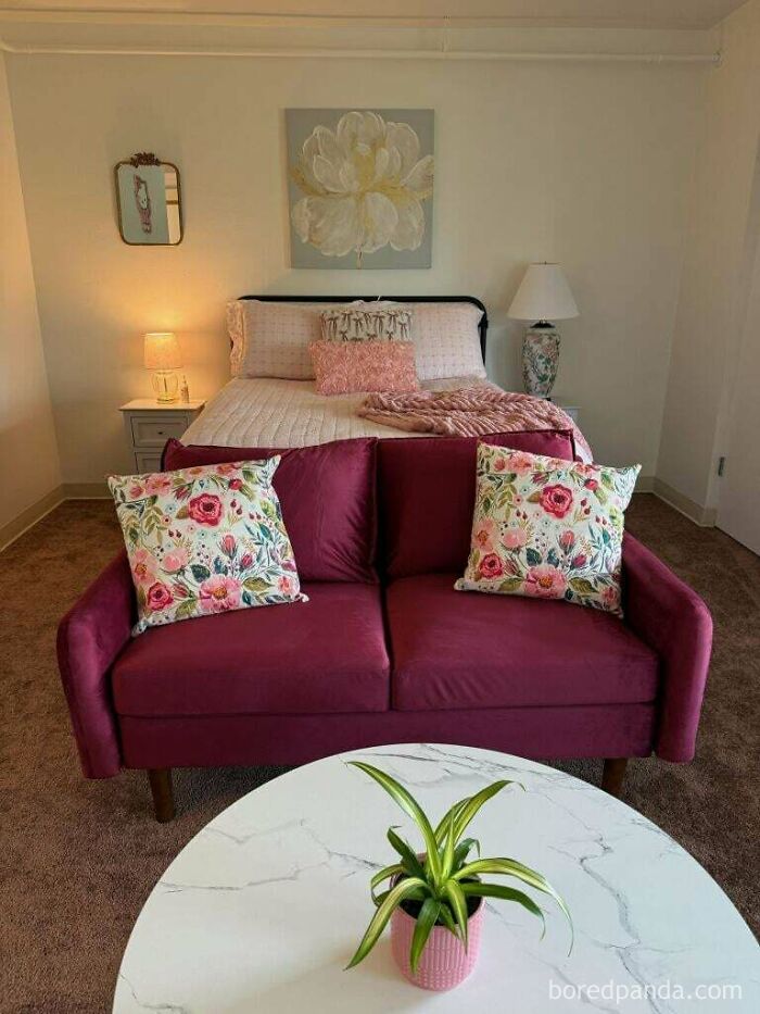 Cozy bedroom with floral pillows and warm lighting creating a wholesome atmosphere