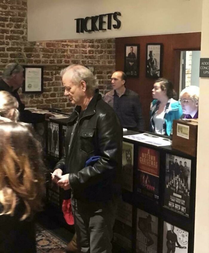 Bill Murray buying tickets at a theater box office capturing a wholesome moment