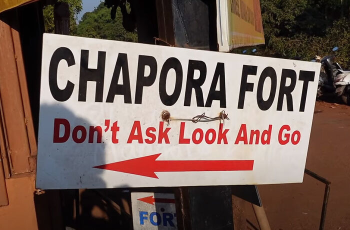 A humorous and somewhat passive-aggressive sign for Chapora Fort, directing visitors without further questions.