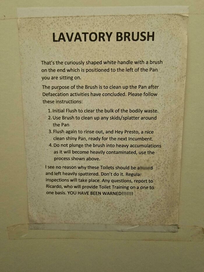 A passive-aggressive note on a wall explaining how to use a lavatory brush and warning about toilet inspections.