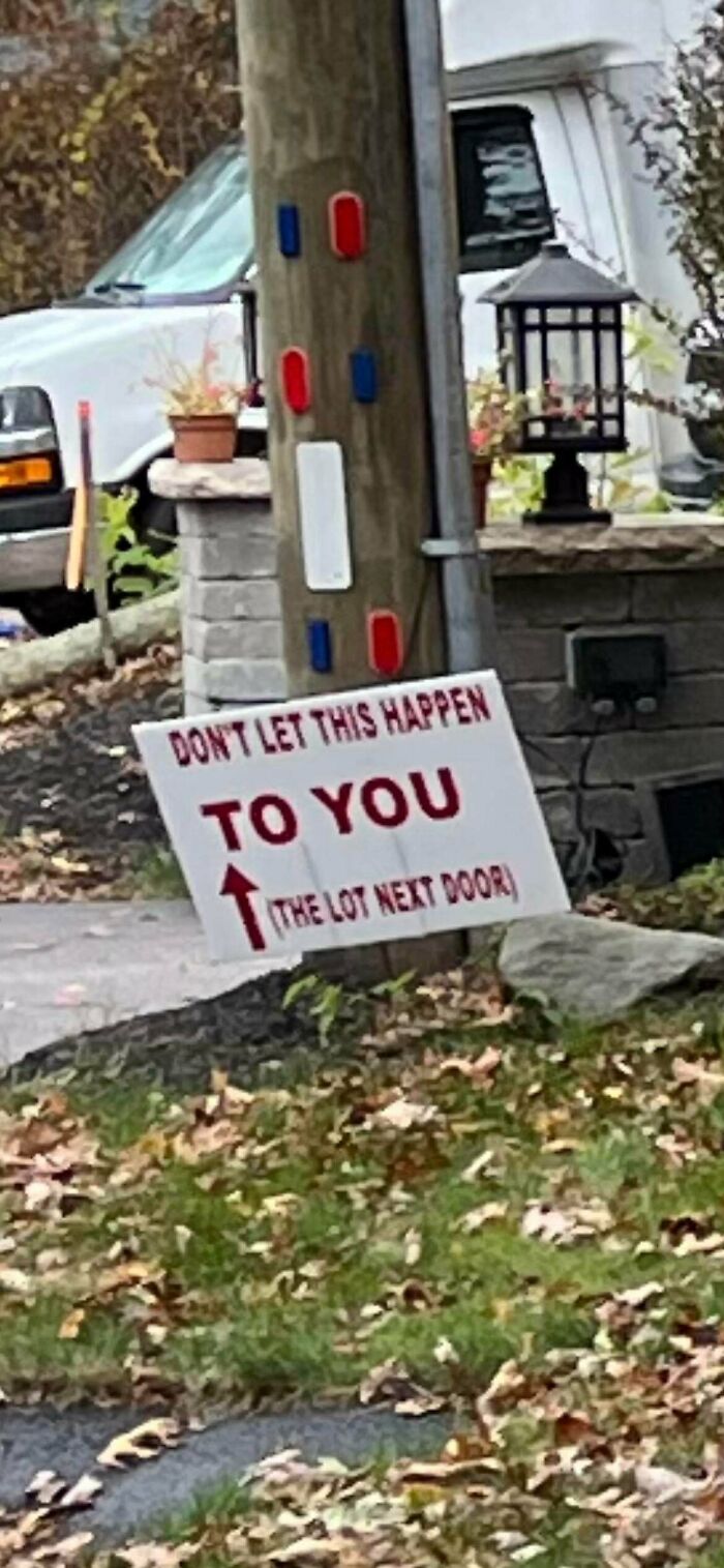 A sign with passive-aggressive notes saying Dont let this happen to you, pointing to the lot next door.