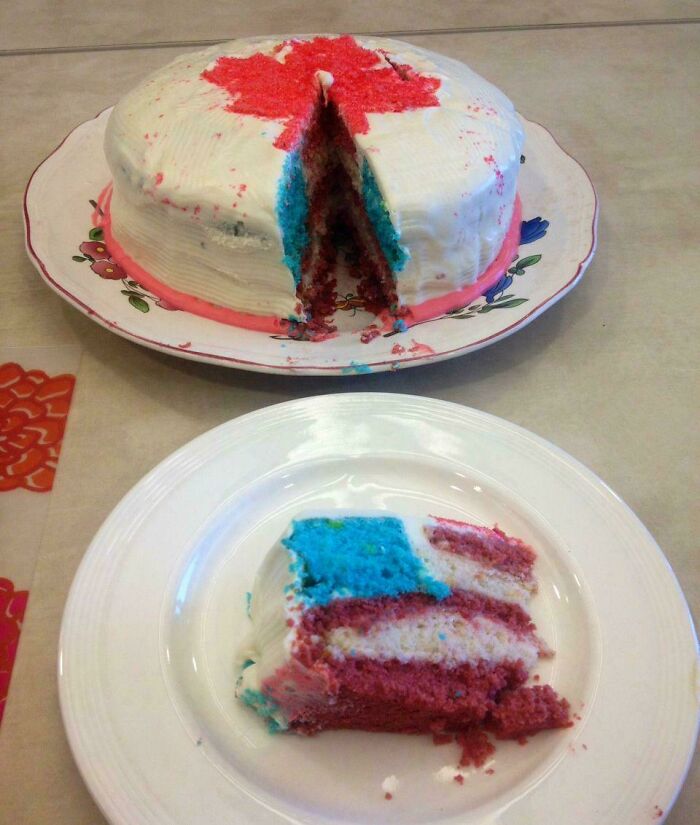 Layered cake with red, white, and blue colors cut to reveal unexpected color pattern inside weird confusing image.