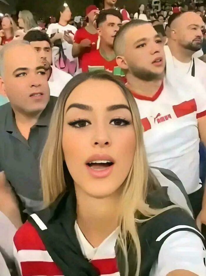 Crowd photo with multiple faces edited to appear weird and confusing, creating a cursed image effect.