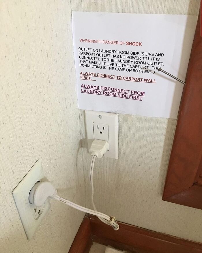 Electrical outlet setup with warning sign showing a technically works but confusing, dumb solution to power connection problems.
