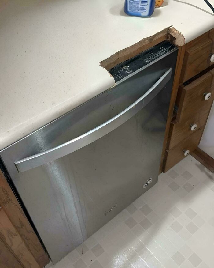 Dishwasher installed with a cutout in the countertop as a technically works but hilariously dumb solution to fit the appliance.