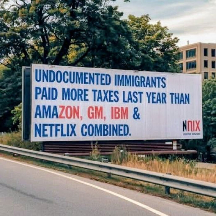 Billboard sign stating undocumented immigrants paid more taxes last year than Amazon, GM, IBM, and Netflix combined, funny confusing sign.