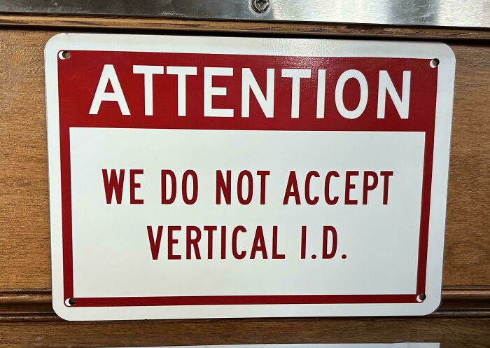 Attention sign with confusing and funny message about not accepting vertical ID, related to bees signs.