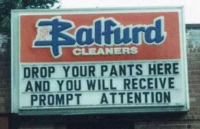 Funny confusing sign outside Balfurd Cleaners humorously inviting customers to drop pants for prompt attention.